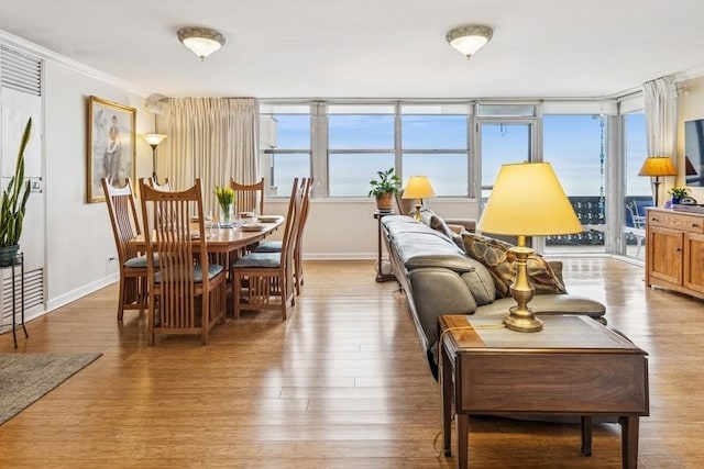 interior space featuring ornamental molding, baseboards, and wood finished floors