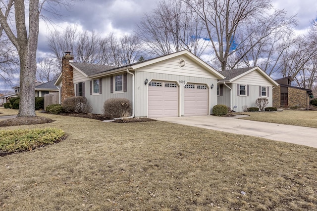 single story home featuring a garage, concrete driveway, a chimney, roof with shingles, and a front lawn