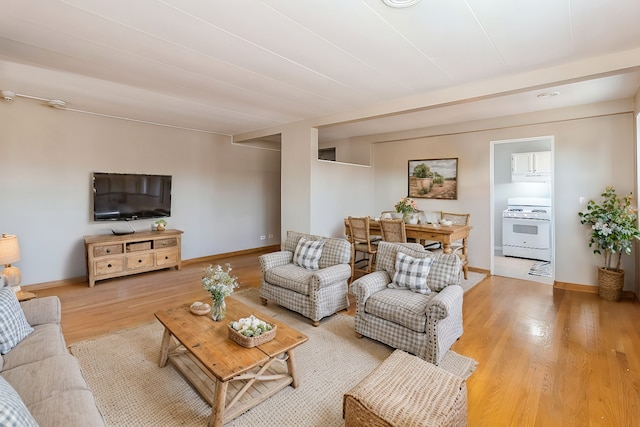 living area featuring light wood-type flooring and baseboards