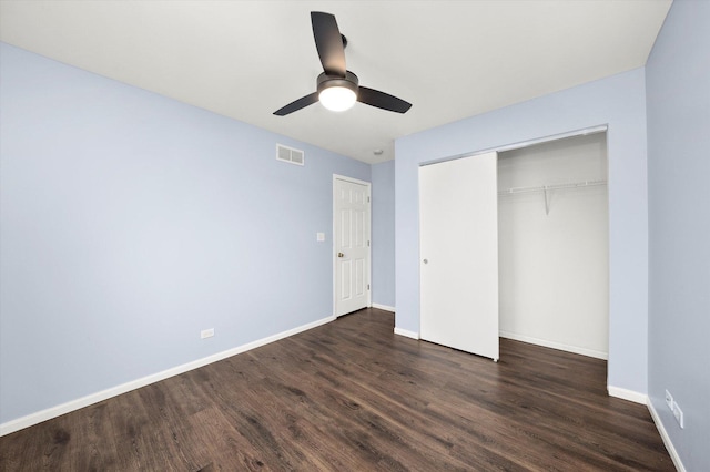 unfurnished bedroom featuring a closet, visible vents, dark wood-type flooring, ceiling fan, and baseboards