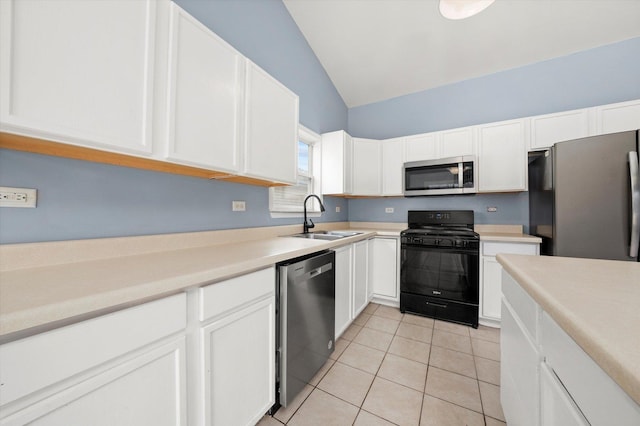 kitchen with light tile patterned floors, white cabinets, stainless steel appliances, light countertops, and a sink