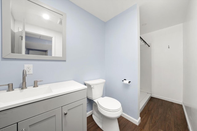 full bathroom with baseboards, visible vents, toilet, wood finished floors, and vanity