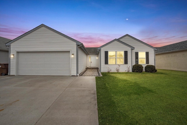 view of front facade featuring concrete driveway, a lawn, and an attached garage