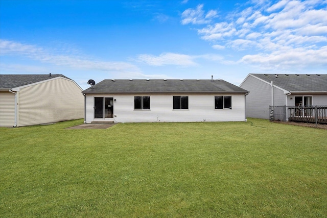 rear view of house featuring a yard