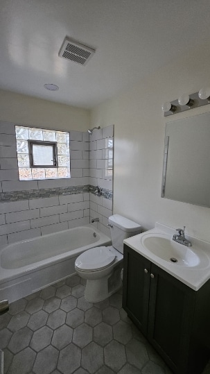 full bathroom with visible vents, toilet, shower / bathtub combination, tile patterned floors, and vanity