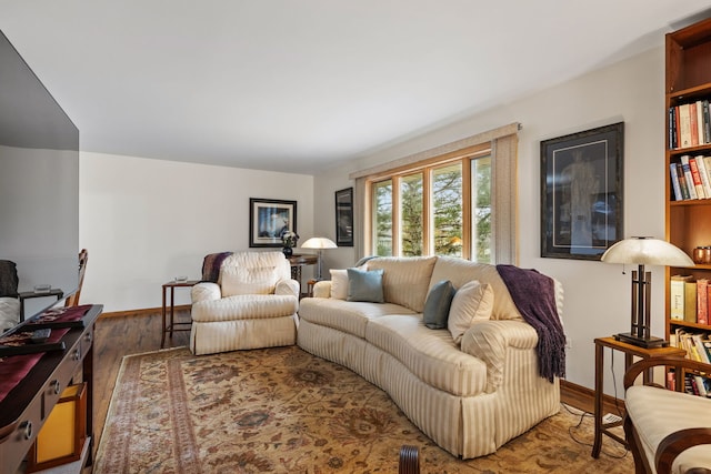 living room featuring baseboards and wood finished floors