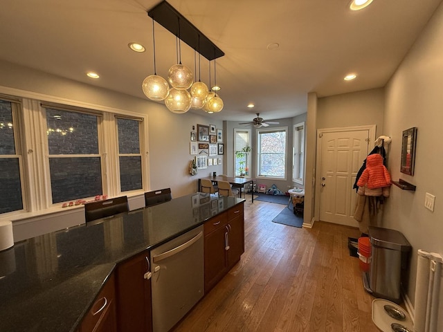 kitchen featuring dark wood finished floors, decorative light fixtures, dishwasher, radiator heating unit, and recessed lighting