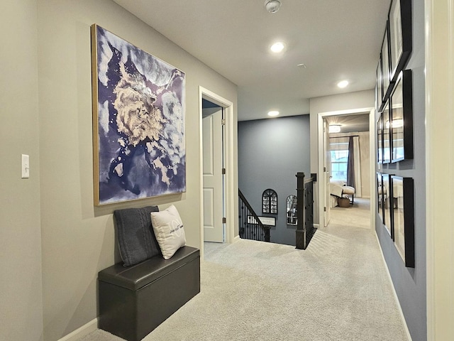 corridor with baseboards, carpet flooring, an upstairs landing, and recessed lighting