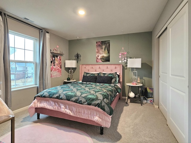 carpeted bedroom featuring visible vents and baseboards