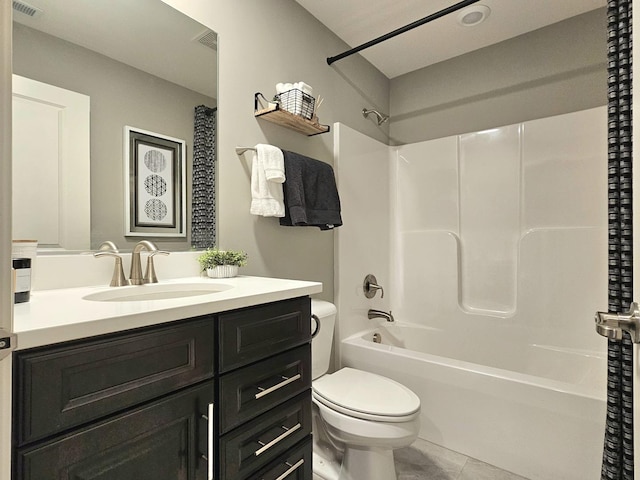 full bathroom with visible vents, toilet, vanity, tile patterned floors, and shower / bathtub combination