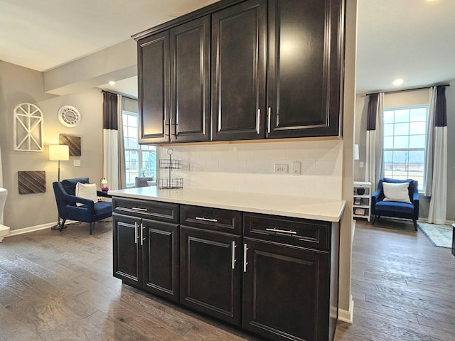 kitchen with dark wood-style floors, tasteful backsplash, and plenty of natural light