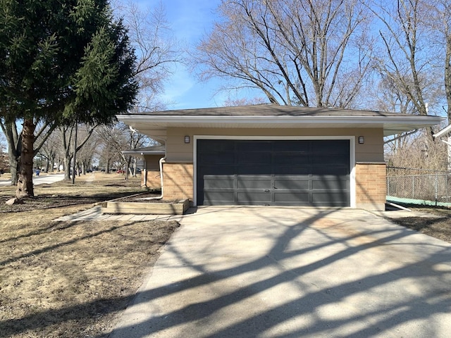 detached garage featuring fence