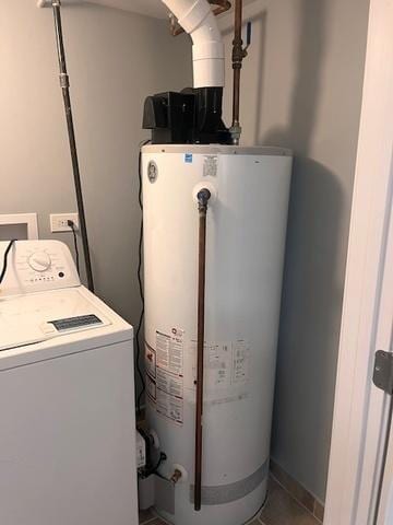 laundry area with water heater, washer / clothes dryer, baseboards, and tile patterned floors