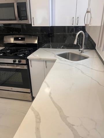 kitchen featuring white cabinetry, appliances with stainless steel finishes, and a sink