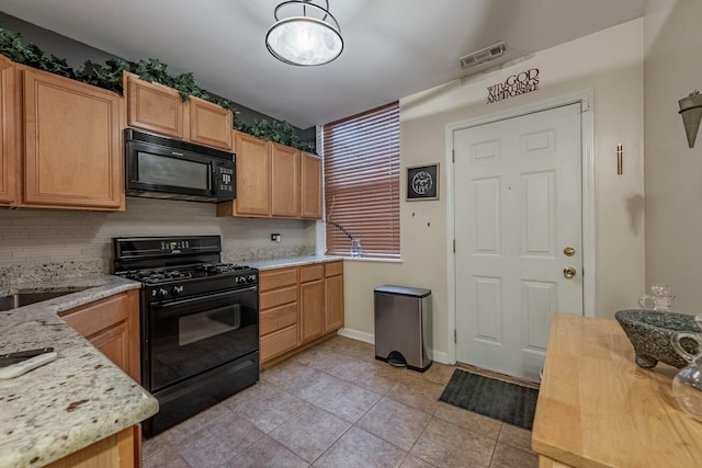 kitchen with light tile patterned floors, visible vents, backsplash, light stone countertops, and black appliances