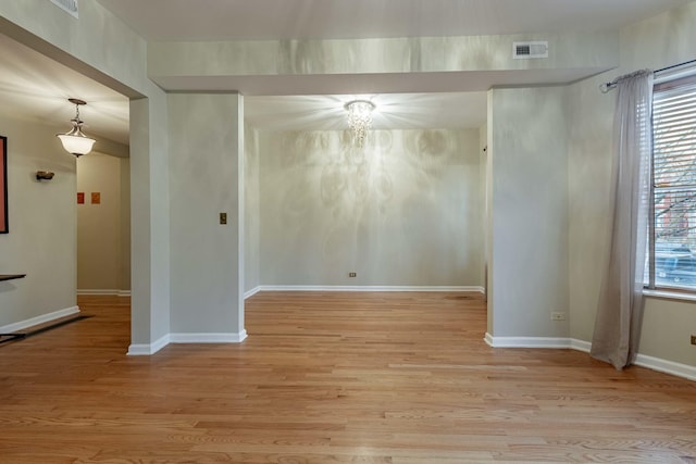 unfurnished room with light wood finished floors and baseboards