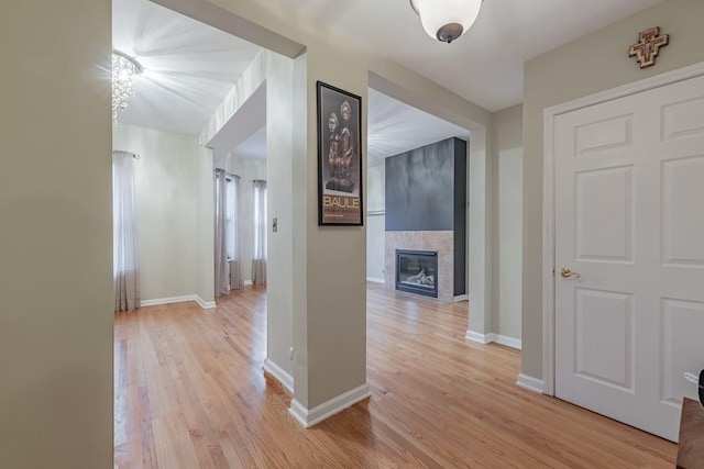 hallway featuring light wood-type flooring and baseboards