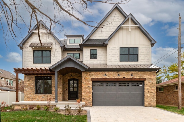 view of front of home featuring a garage, decorative driveway, board and batten siding, and a standing seam roof