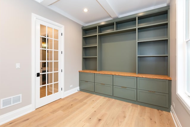 unfurnished room featuring recessed lighting, visible vents, baseboards, light wood finished floors, and beamed ceiling