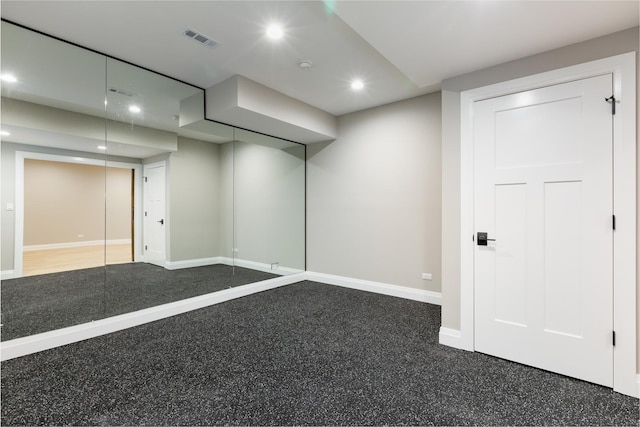 below grade area with baseboards, visible vents, and recessed lighting