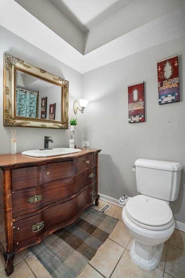 full bath featuring vanity, tile patterned floors, baseboards, and toilet