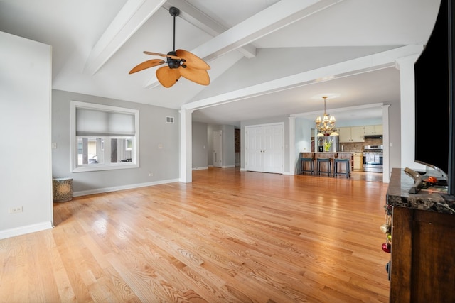 living area featuring visible vents, light wood finished floors, lofted ceiling with beams, and ceiling fan with notable chandelier
