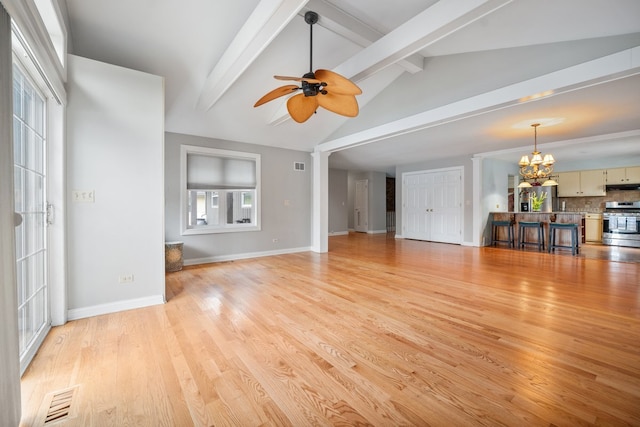 unfurnished living room featuring lofted ceiling with beams, light wood finished floors, visible vents, and ceiling fan with notable chandelier