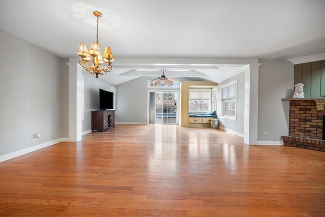 unfurnished living room with light wood finished floors, baseboards, lofted ceiling, ceiling fan with notable chandelier, and a fireplace