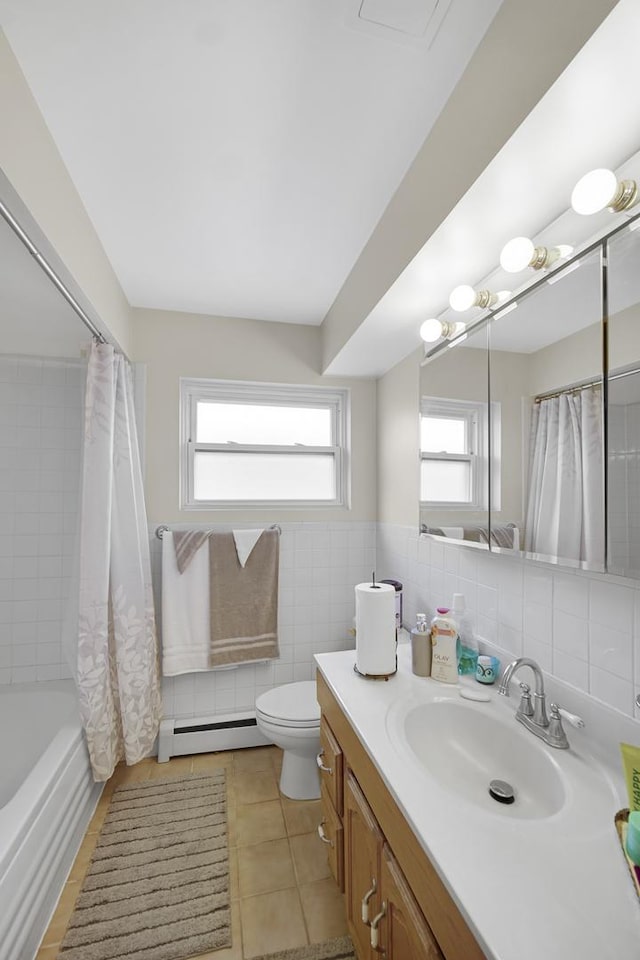 full bathroom with tile walls, toilet, a baseboard heating unit, vanity, and tile patterned flooring