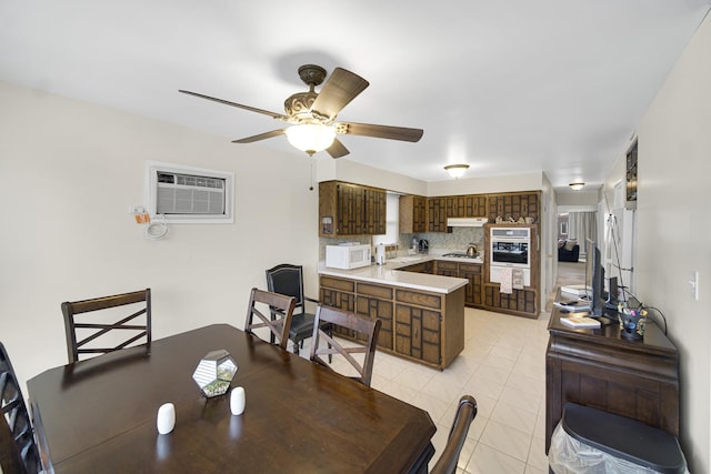 dining area with ceiling fan, a wall mounted AC, and light tile patterned flooring