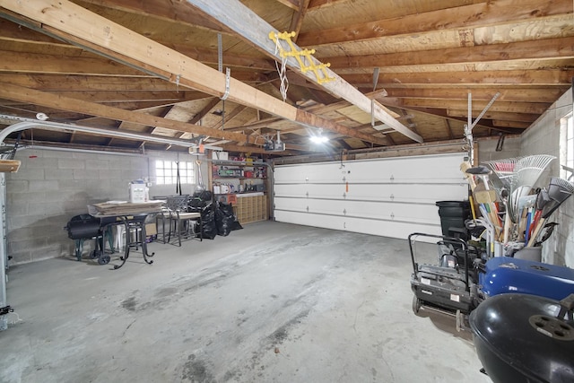 garage with concrete block wall and a garage door opener