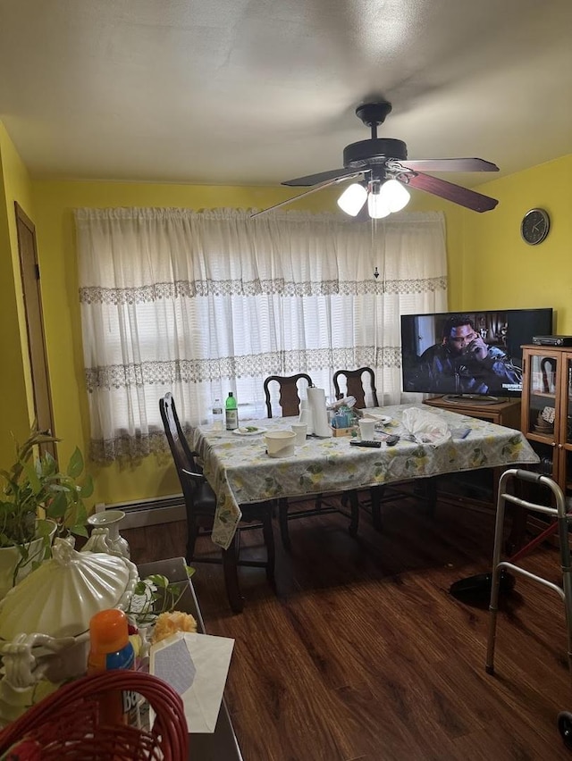 dining area with a baseboard radiator, ceiling fan, and wood finished floors