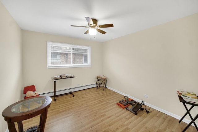 miscellaneous room featuring light wood-type flooring, baseboards, a baseboard heating unit, and ceiling fan