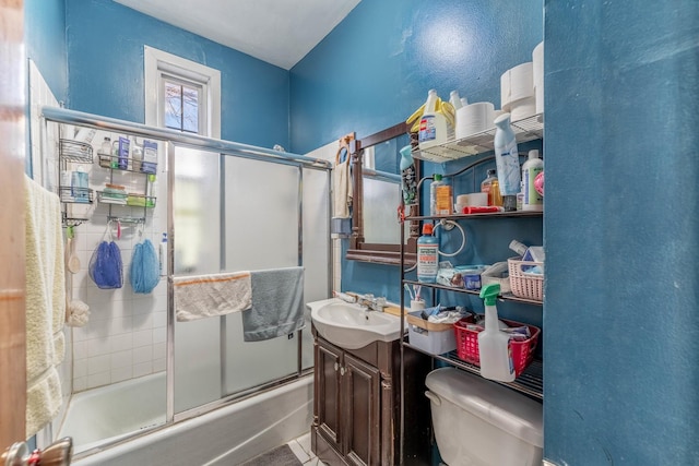 bathroom with shower / bath combination with glass door, vanity, and toilet