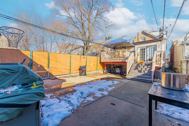 view of patio / terrace featuring stairway, fence, grilling area, and a wooden deck