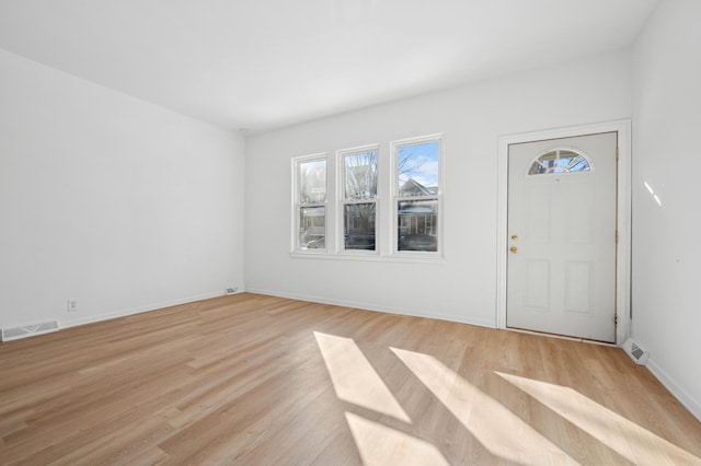 entryway featuring light wood-style floors, baseboards, and visible vents