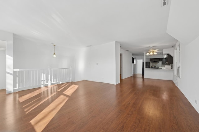 unfurnished living room featuring a ceiling fan, visible vents, and hardwood / wood-style flooring