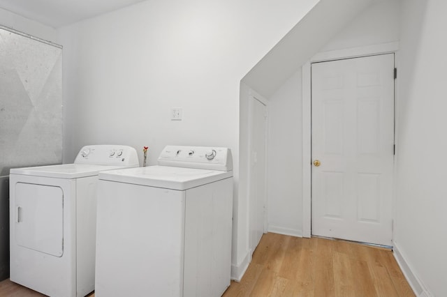 laundry room featuring laundry area, independent washer and dryer, and light wood-style flooring