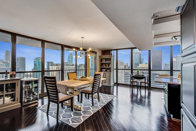 dining area featuring dark wood-type flooring, a view of city, a chandelier, and floor to ceiling windows