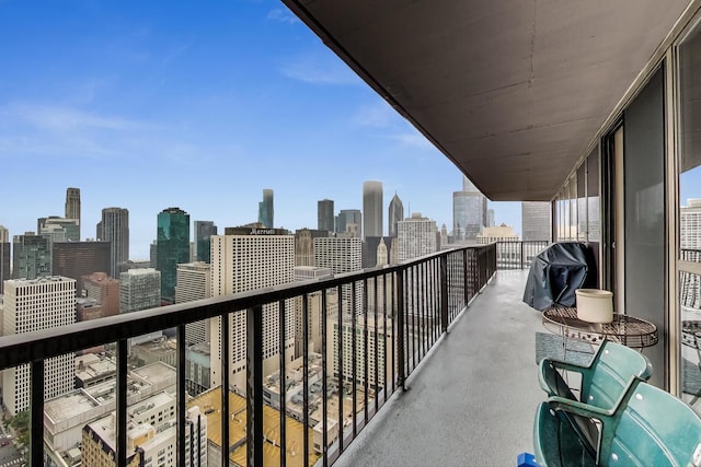 balcony with a view of city and grilling area