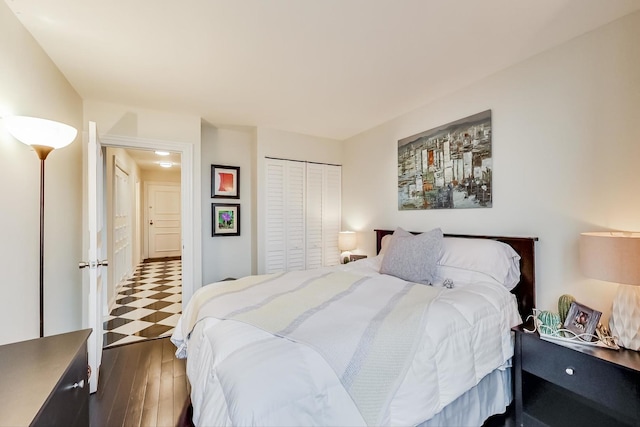 bedroom with a closet and dark wood finished floors