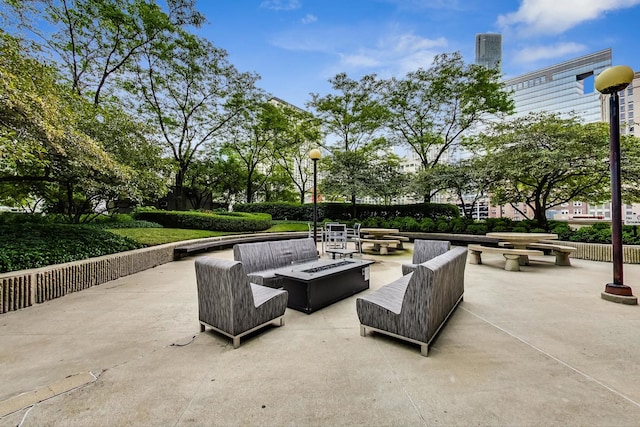 view of patio featuring an outdoor living space with a fire pit