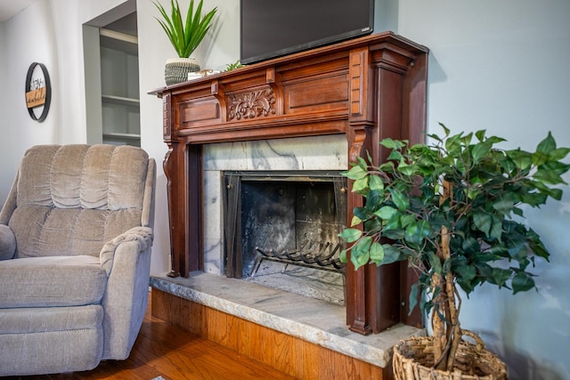 sitting room with wood finished floors and a premium fireplace