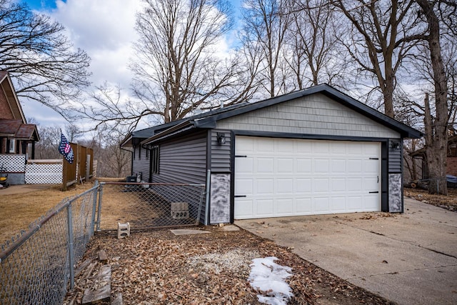 view of home's exterior with a garage, stone siding, and fence