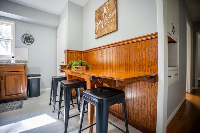 interior space with baseboards and decorative backsplash