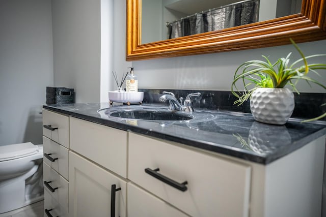 bathroom featuring vanity and toilet