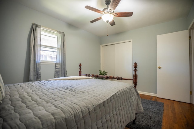 bedroom featuring a closet, ceiling fan, baseboards, and wood finished floors