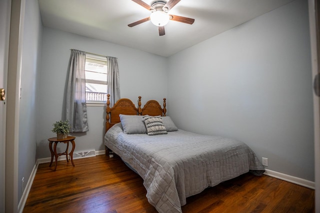 bedroom with a ceiling fan, baseboards, and wood finished floors