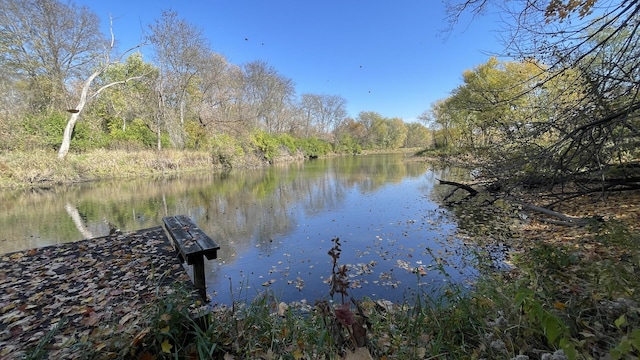 dock area featuring a water view and a forest view