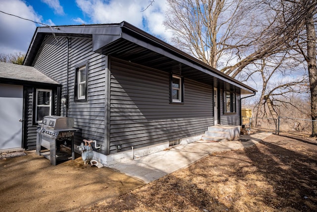 view of home's exterior featuring fence